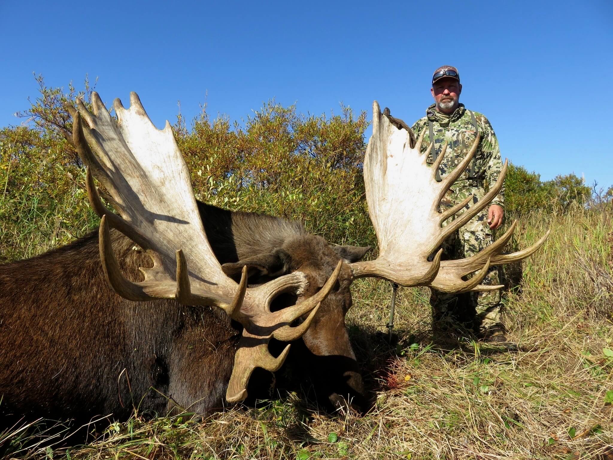 Hunter with a trophy Alaskan–Yukon bull moose